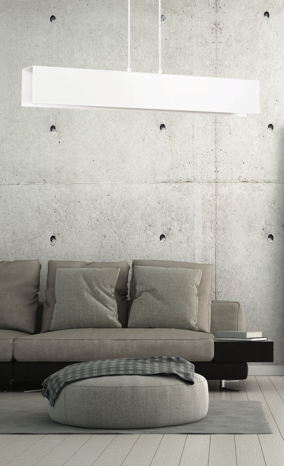 Mise en situation devant mur béton, luminaire linéaire blanc suspendu au-dessus d'un canapé