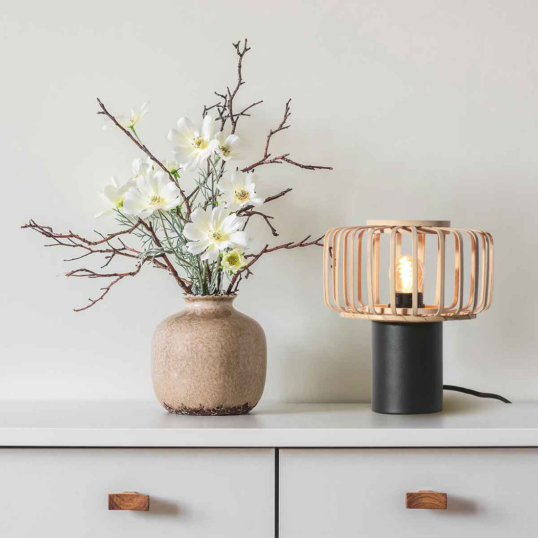 Small black Bloeba 4143ZW table lamp with a natural bamboo lampshade