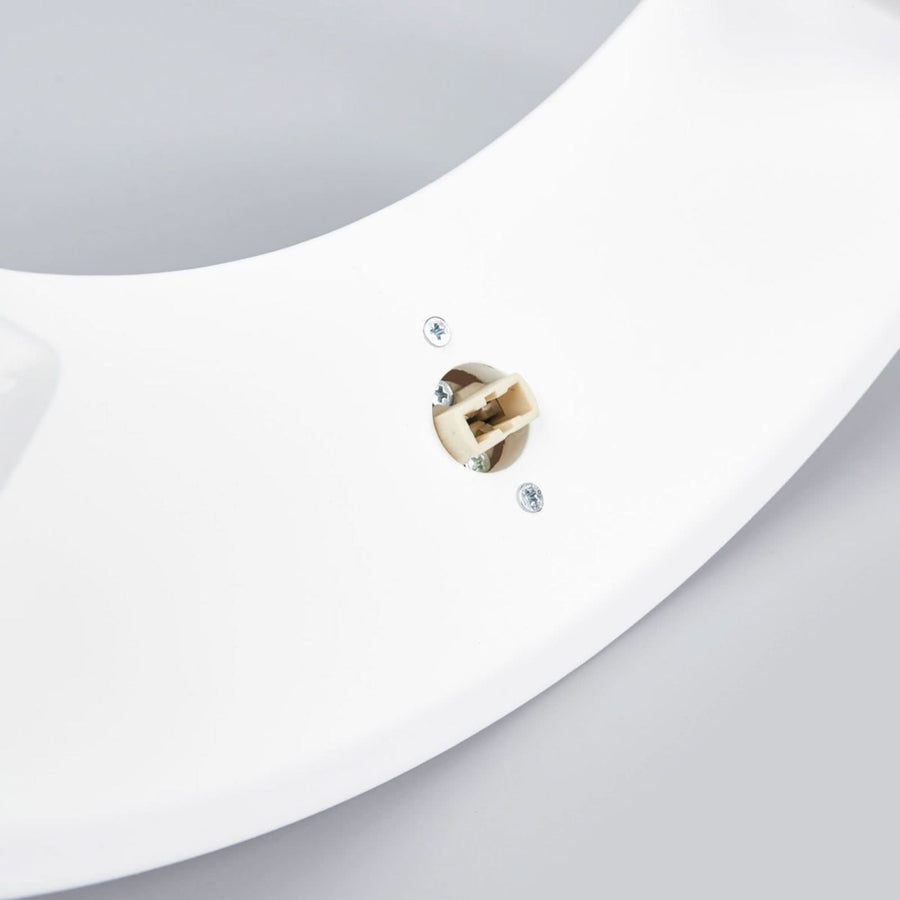Gros plan du dessous de l'applique, montrant le raccord électrique et les vis de fixation.