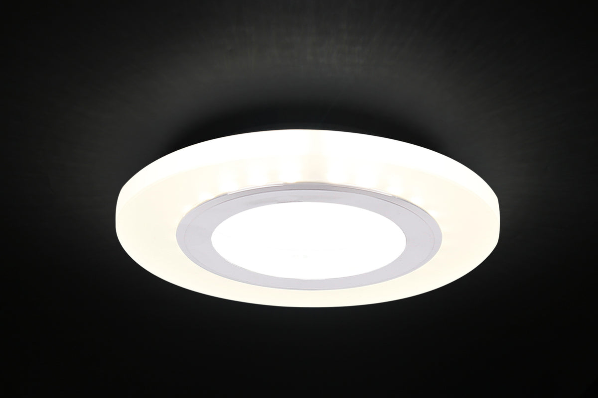 Spot LED allumé dans un plafond sombre, halo lumineux blanc diffus autour