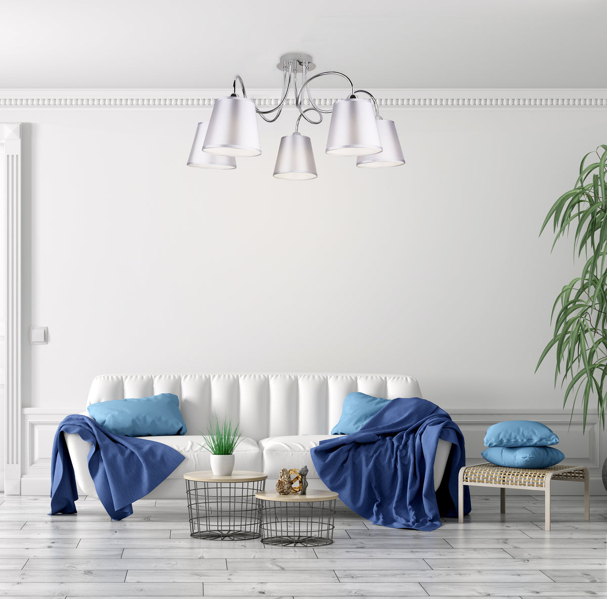 Mise en ambiance salon blanc, suspension fixée au plafond au-dessus canapé et coussins bleus.