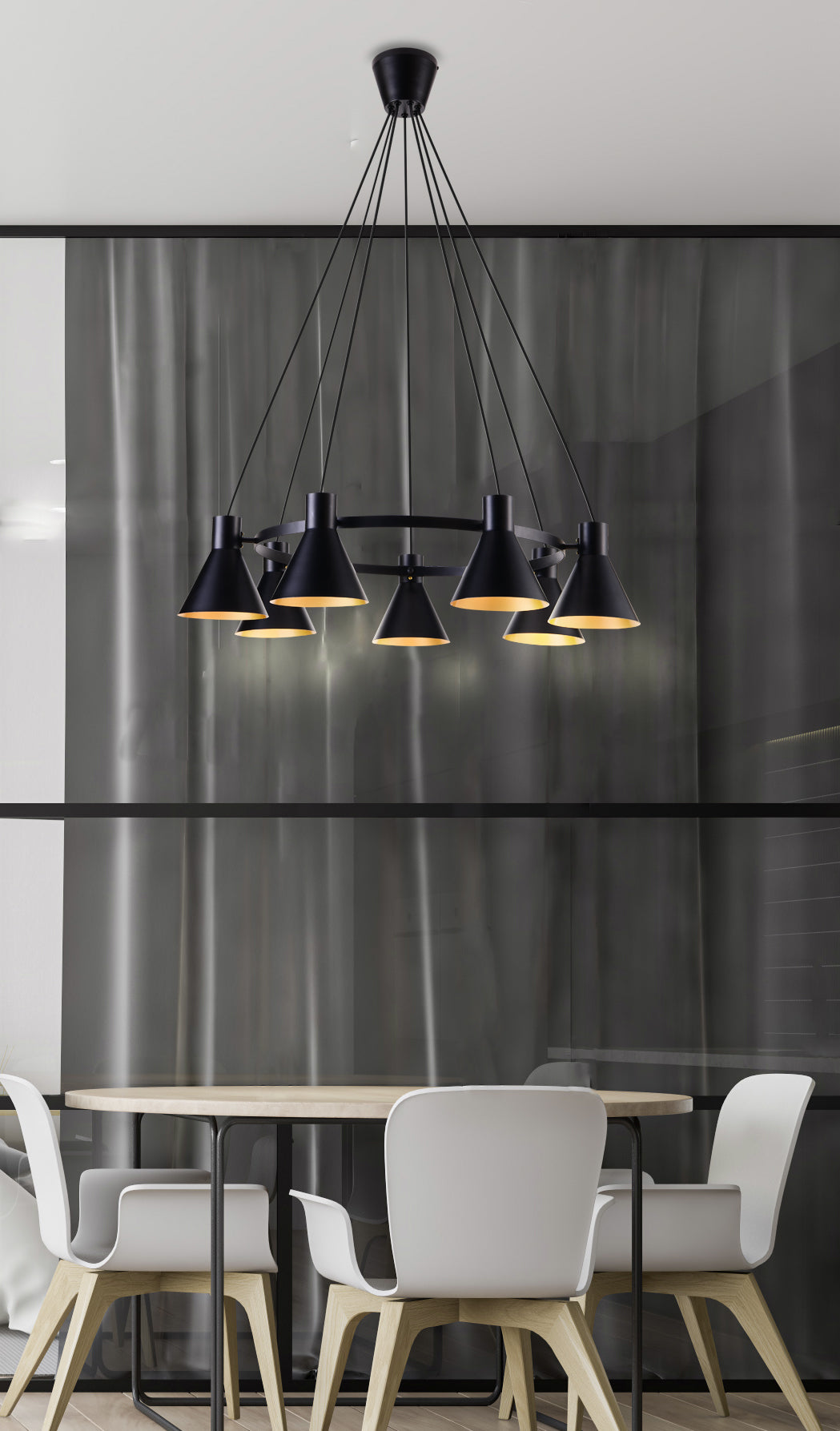 Suspension noire allumée au-dessus d'une table ronde dans un intérieur gris et moderne.