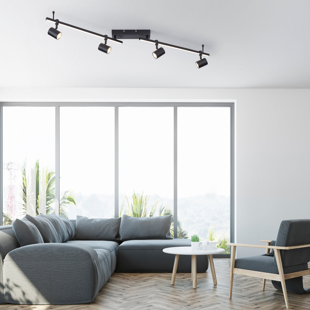 Mise en ambiance du plafonnier allumé au-dessus d'un salon moderne avec canapé et baies vitrées.