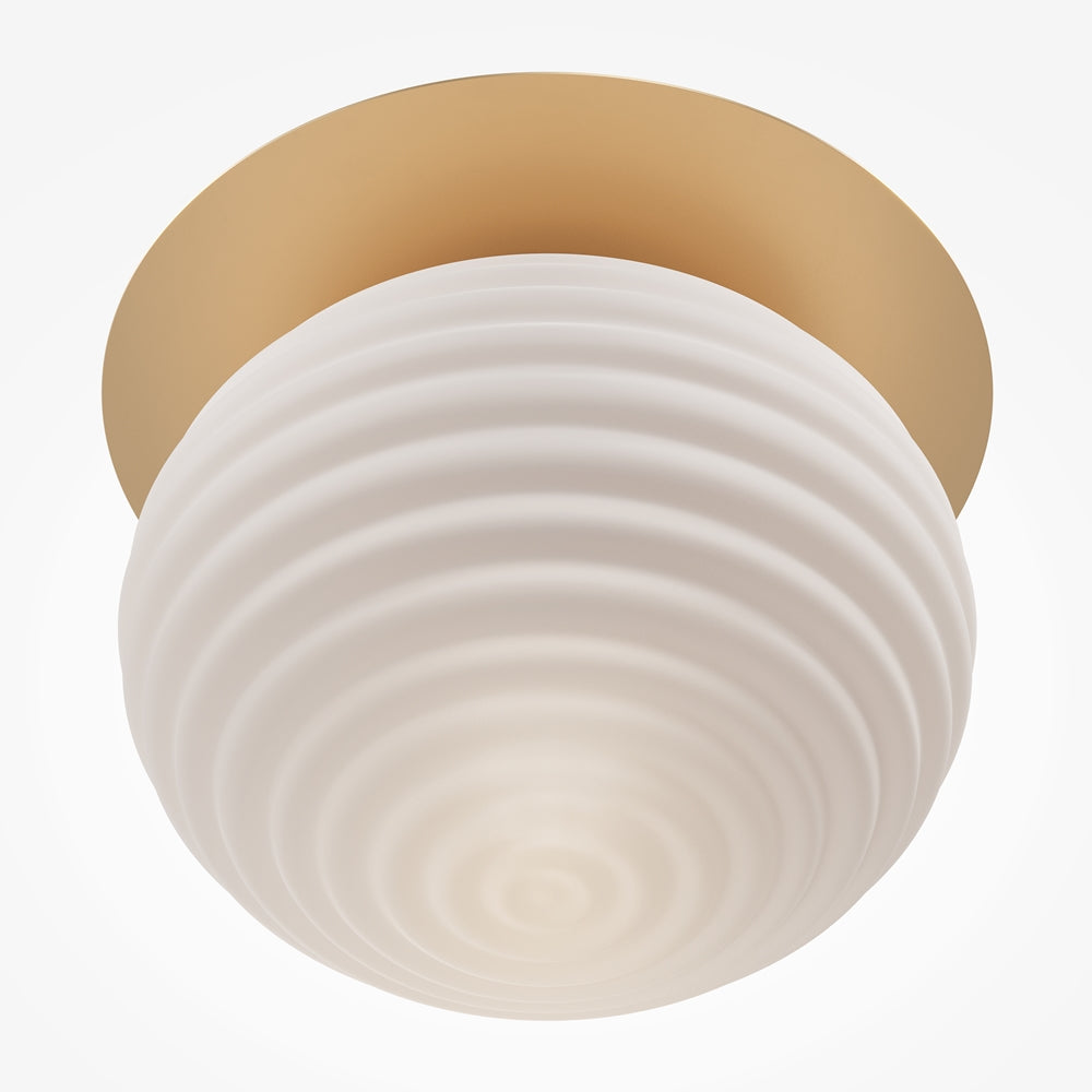 Vue rapprochée du bas de la sphère striée, verre opalin diffusant une lumière chaude