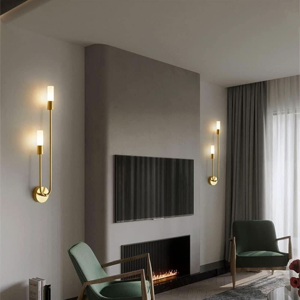 Salon contemporain avec deux appliques dorées encadrant un mur télévision et foyer.