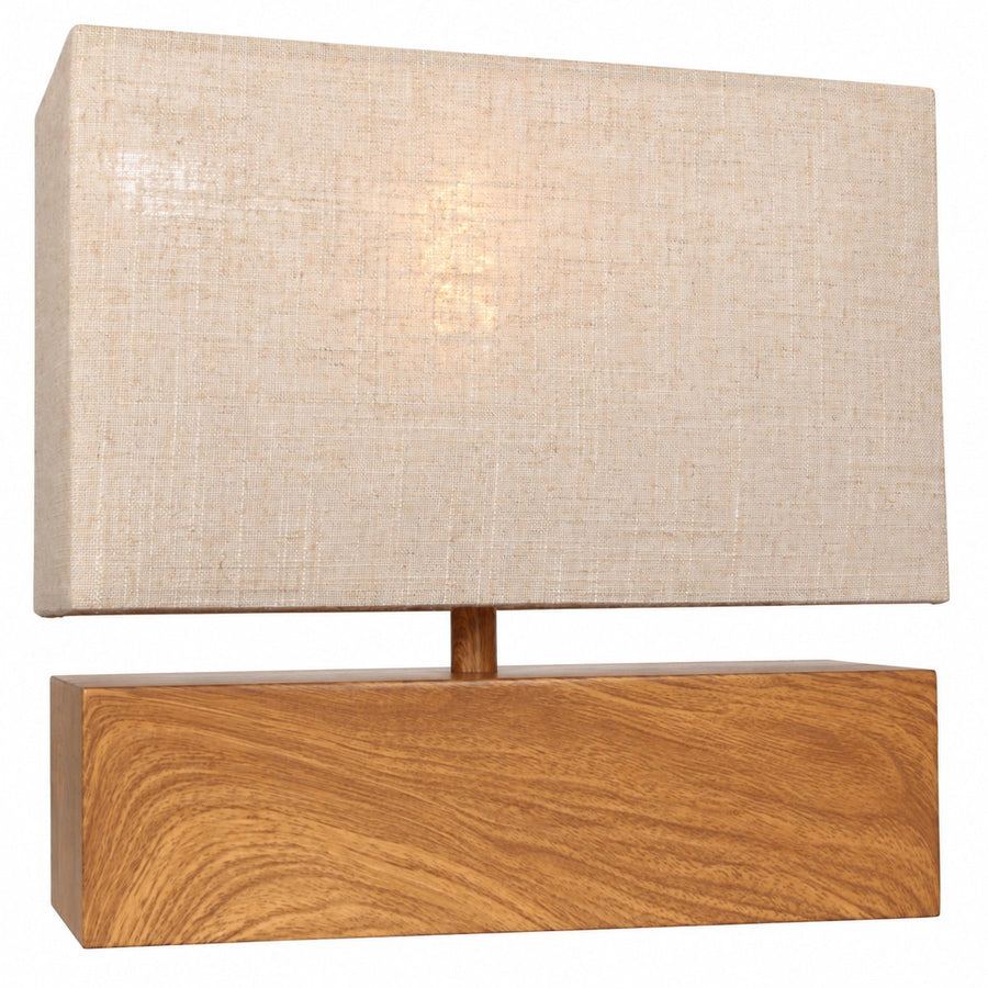 Lampe allumée de face, abat-jour beige diffusant une lumière chaude.