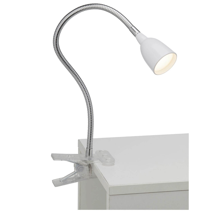 Lampe de bureau à pince fixée sur une surface blanche, montrant le système d'attache transparent.