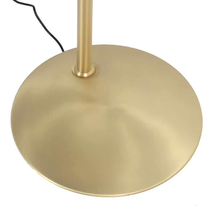 Détail de la base ronde dorée et du câble noir sortant à l'arrière.