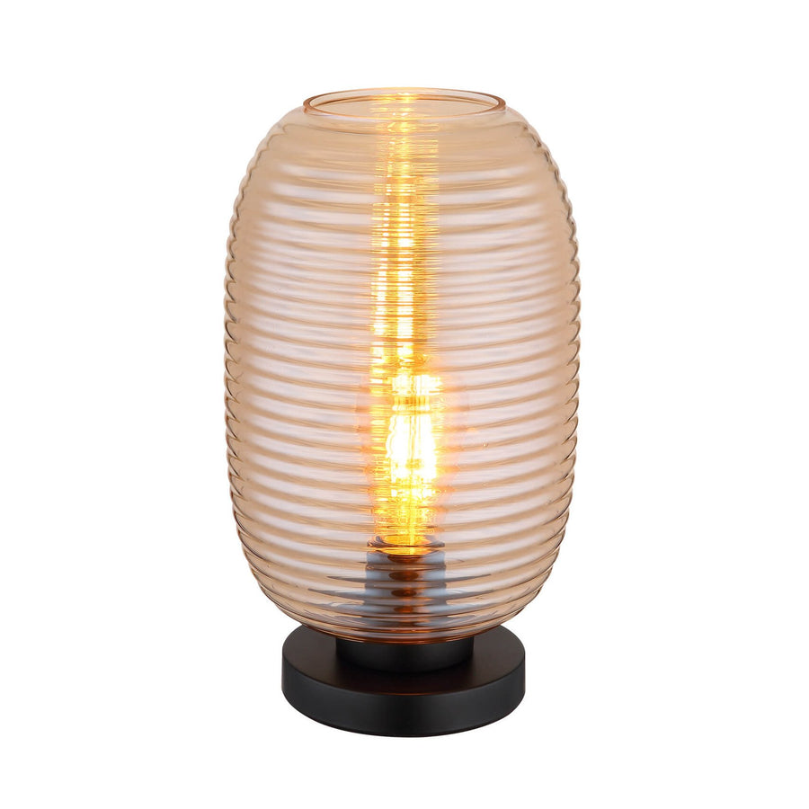 Lampe à poser de face, abat-jour en verre ambré strié sur socle noir mat
