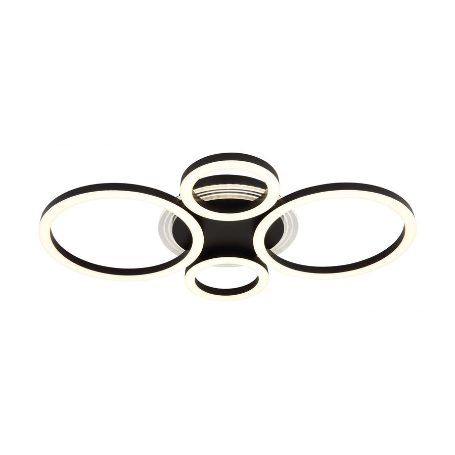 Plafonnier noir mat vu de face, quatre anneaux LED allumés en blanc.