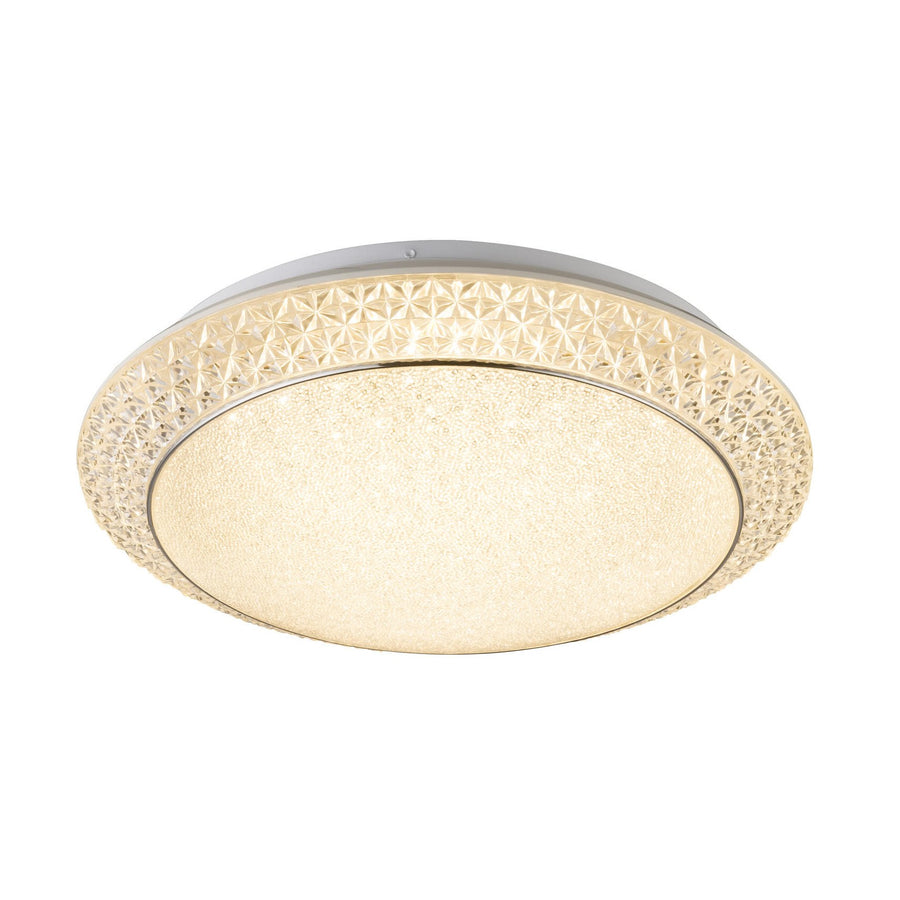 Plafonnier rond allumé vu de face sur fond blanc, verre dépoli et cerclage ajouré