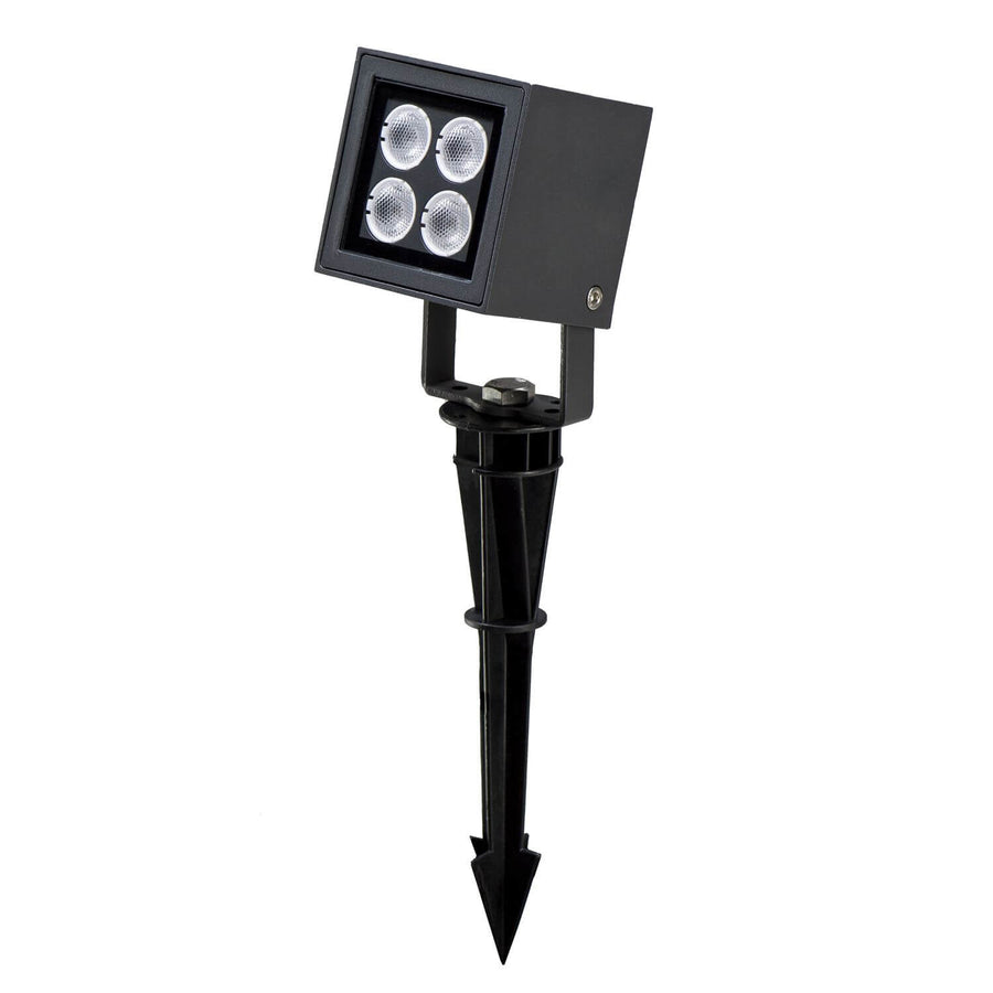 Projecteur extérieur anthracite à piquer, tête carrée et quatre LEDs visibles.