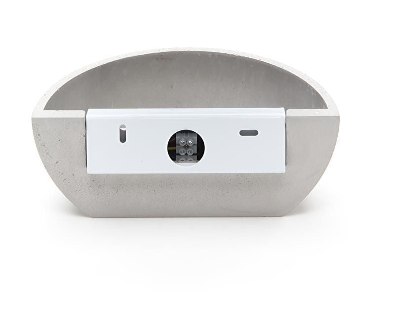 Arrière du luminaire gris avec boîtier blanc, bornier et fentes de fixation.