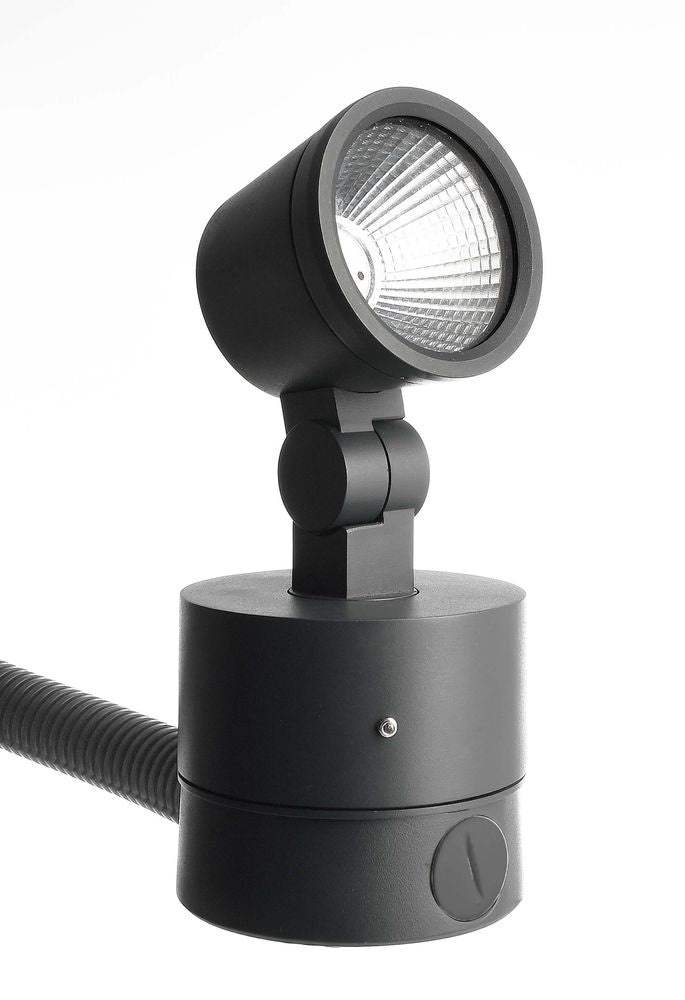 Projecteur noir avec arrivée de câble gainé sur sa base ronde.