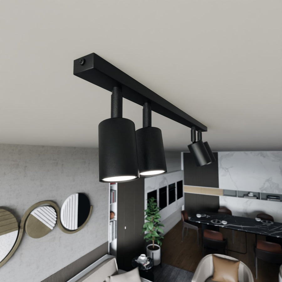 Vue en plongée du luminaire noir installé au plafond près de la salle à manger.