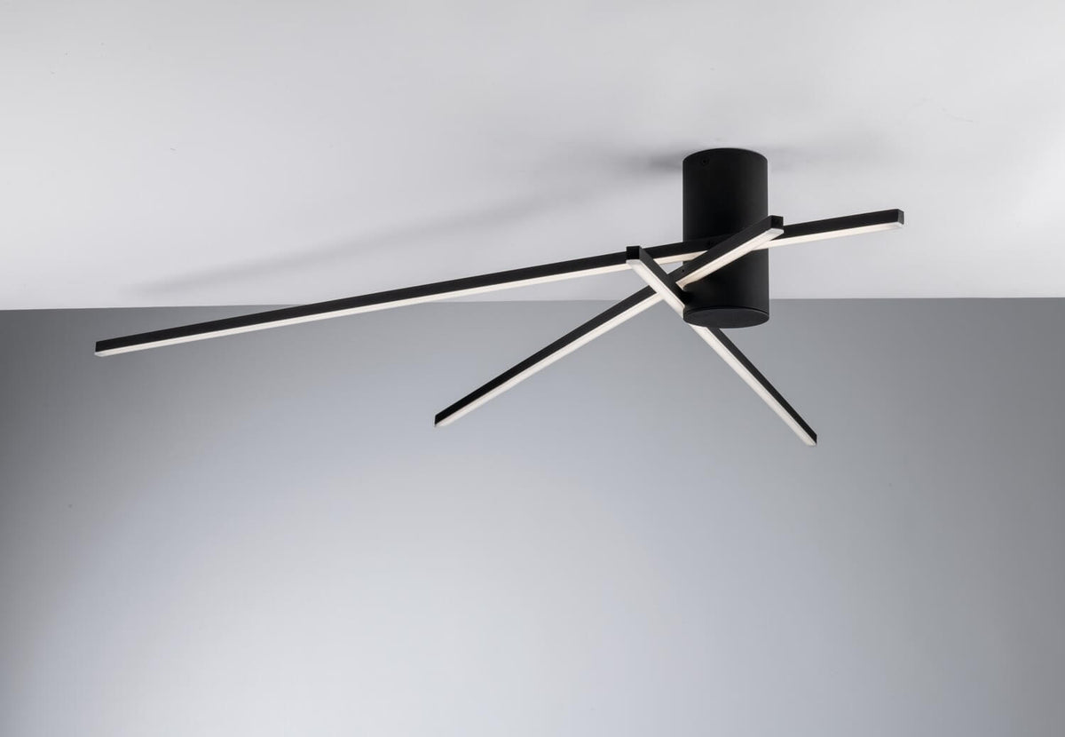 Détail du socle cylindrique noir et des bras LED croisés éclairés