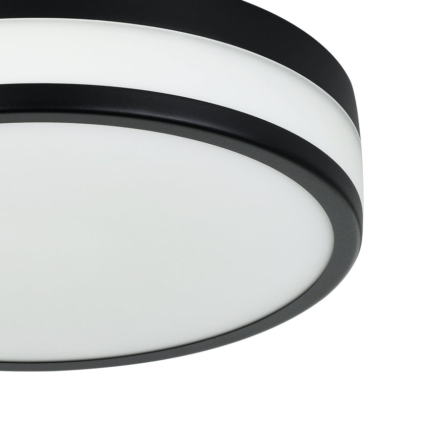 Gros plan sur le cerclage noir et le diffuseur blanc du plafonnier.