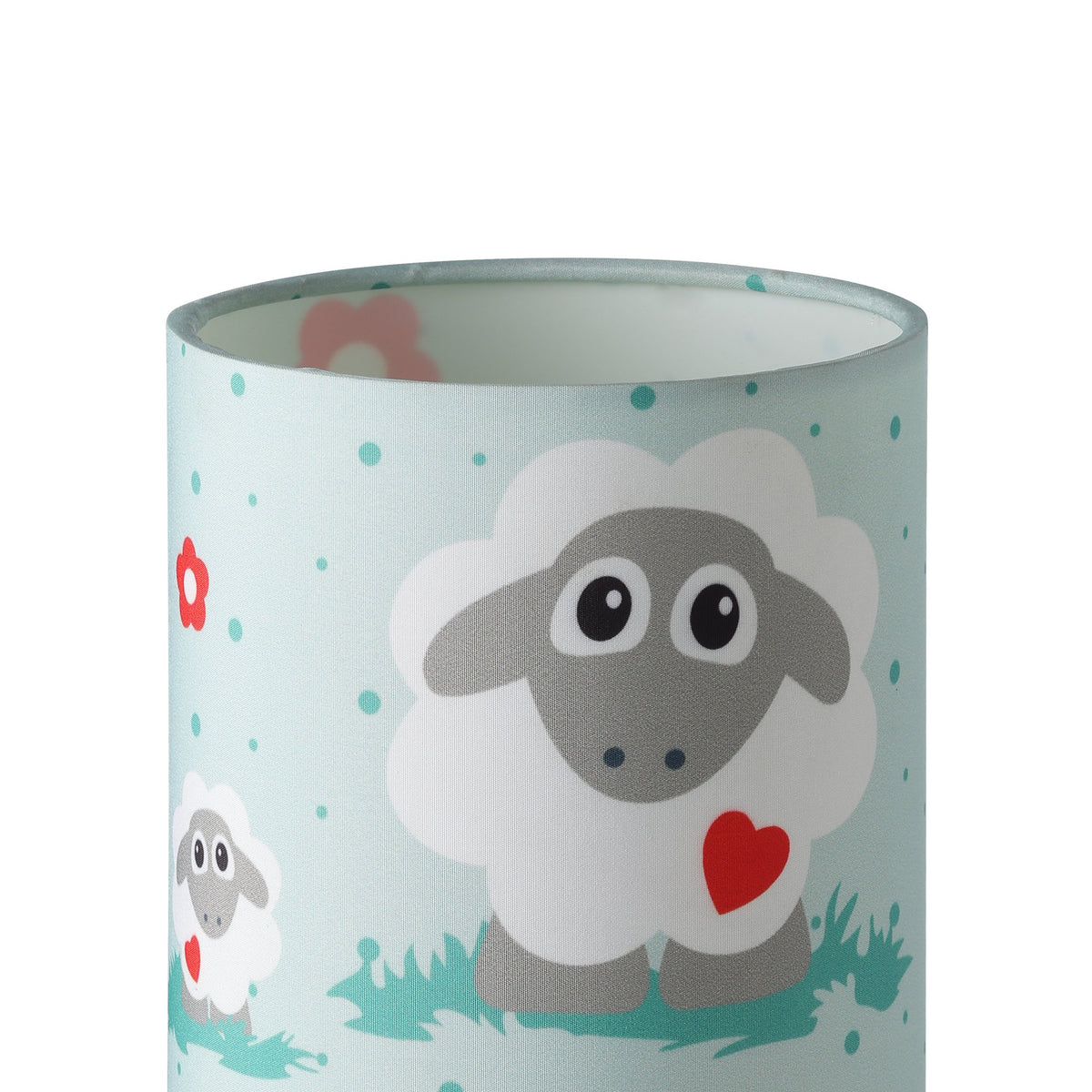 Gros plan sur l'abat-jour textile, motif mouton et fleurs, texture tissée.