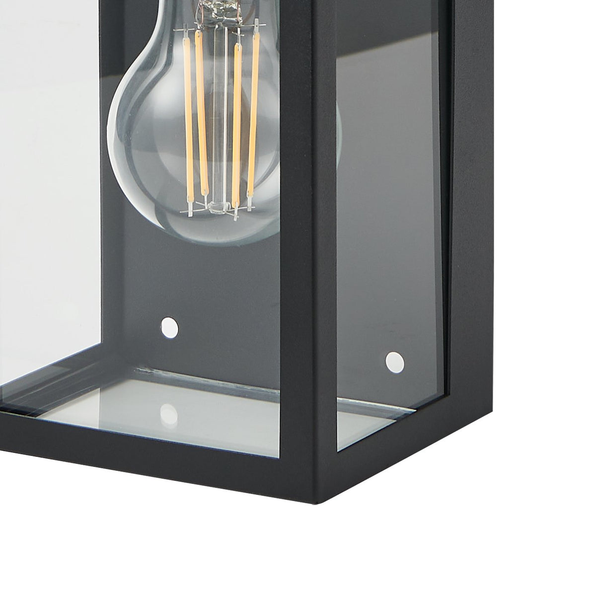 Gros plan sur le bas du luminaire, ampoule à filament doré et vis de fixation