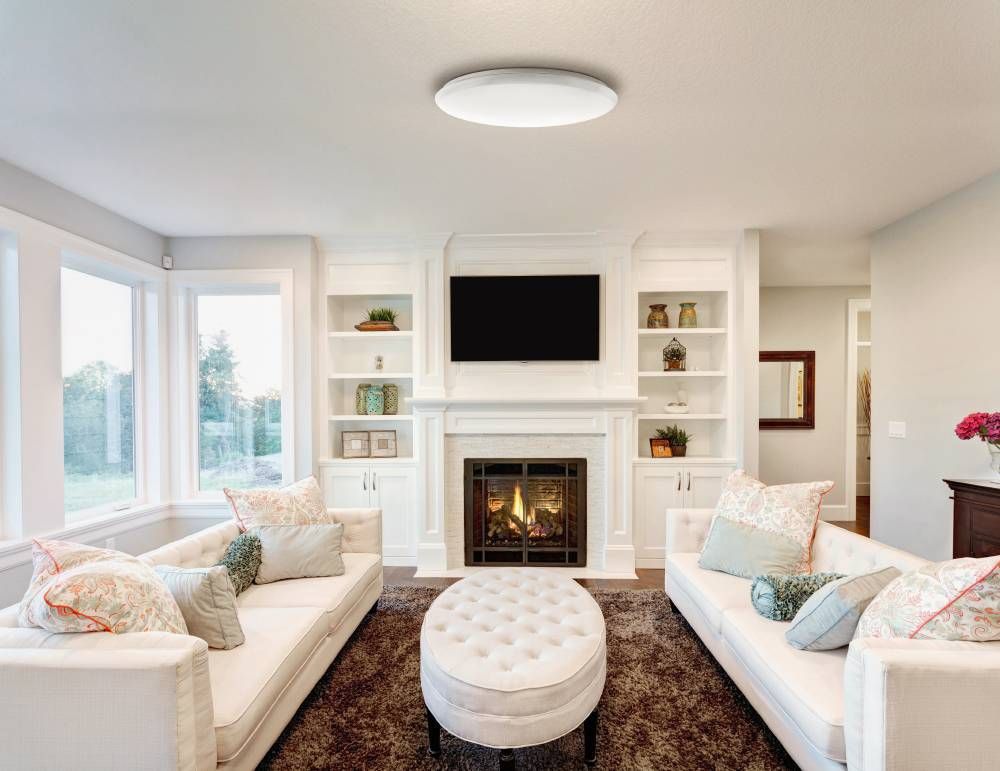 Vue rapprochée du luminaire rond éclairant un séjour contemporain très lumineux