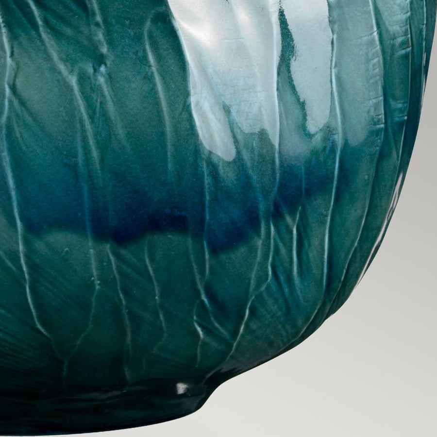 Gros plan sur l'émail bleu craquelé de la base sphérique en porcelaine