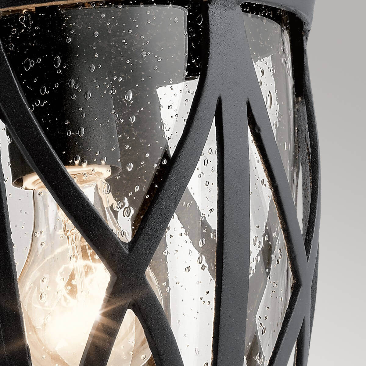 Gros plan sur le verre embué et l'ampoule allumée à l'intérieur.