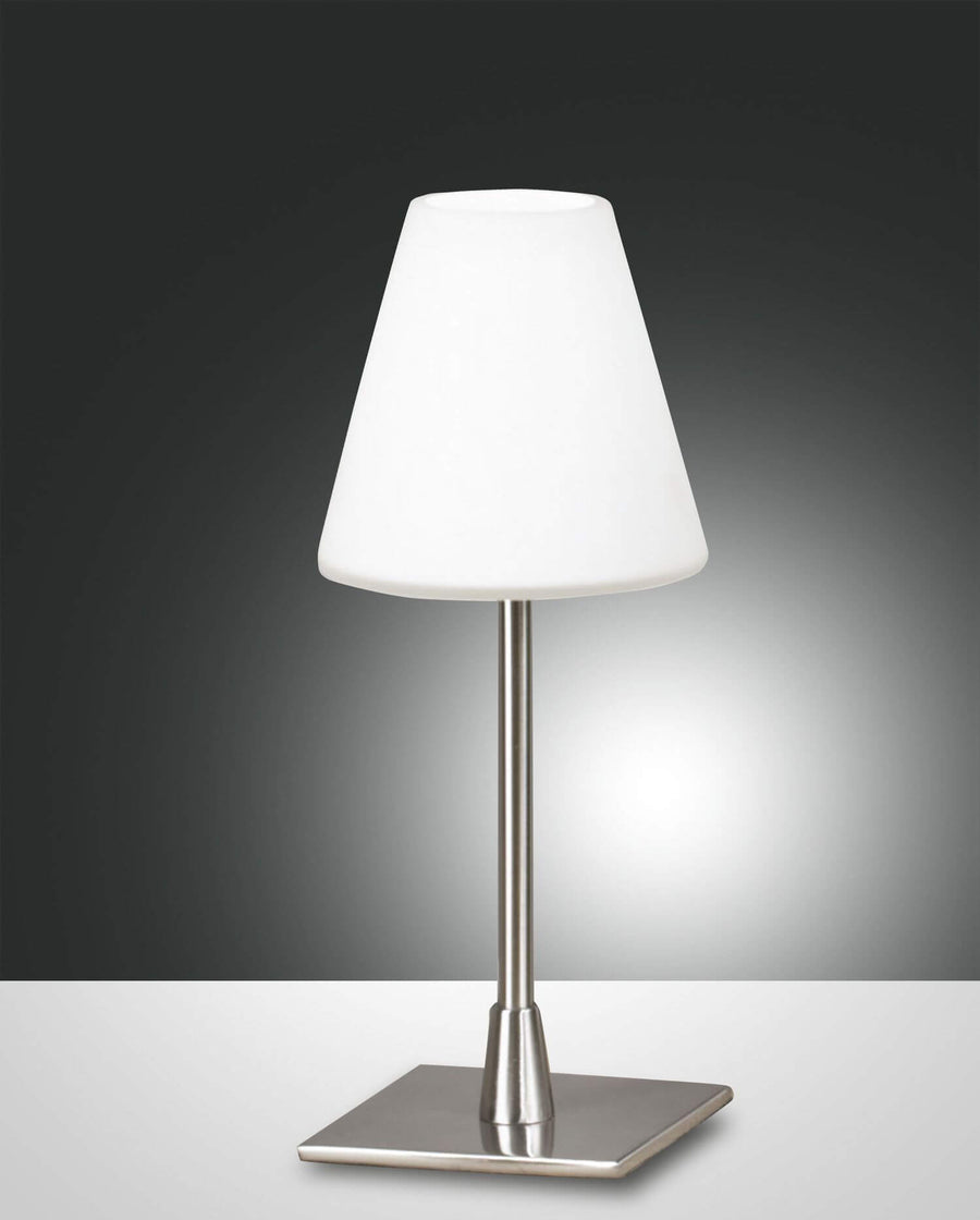 Produit de face sur fond gris dégradé, lampe à poser chromée avec abat-jour conique blanc.
