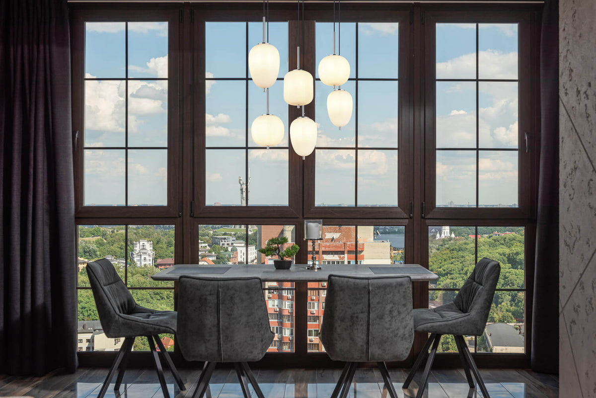Mise en ambiance au-dessus d'une table devant une grande baie vitrée urbaine