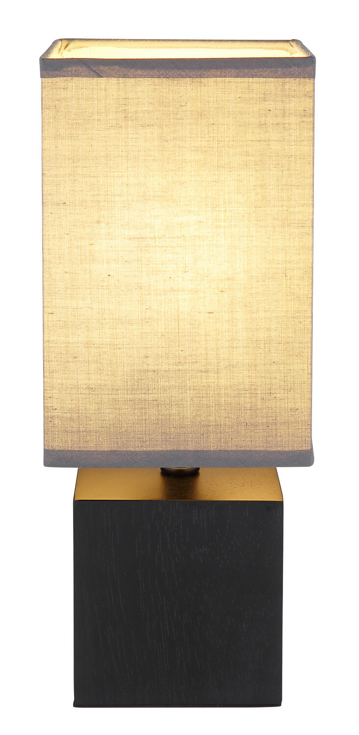 Vue de face de la lampe allumée, abat-jour beige et socle noir doré
