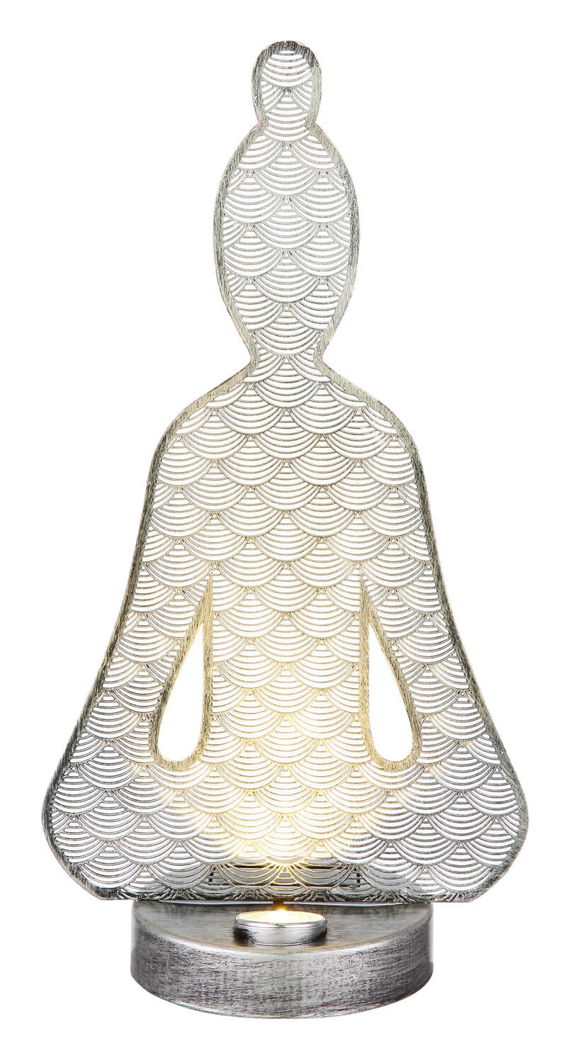 Luminaire éclairé de face, la lumière chaude traverse les découpes latérales.