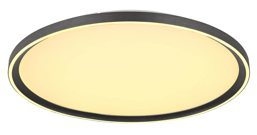 Luminaire éclairé en lumière chaude, contraste du cerclage sombre et du verre opalin