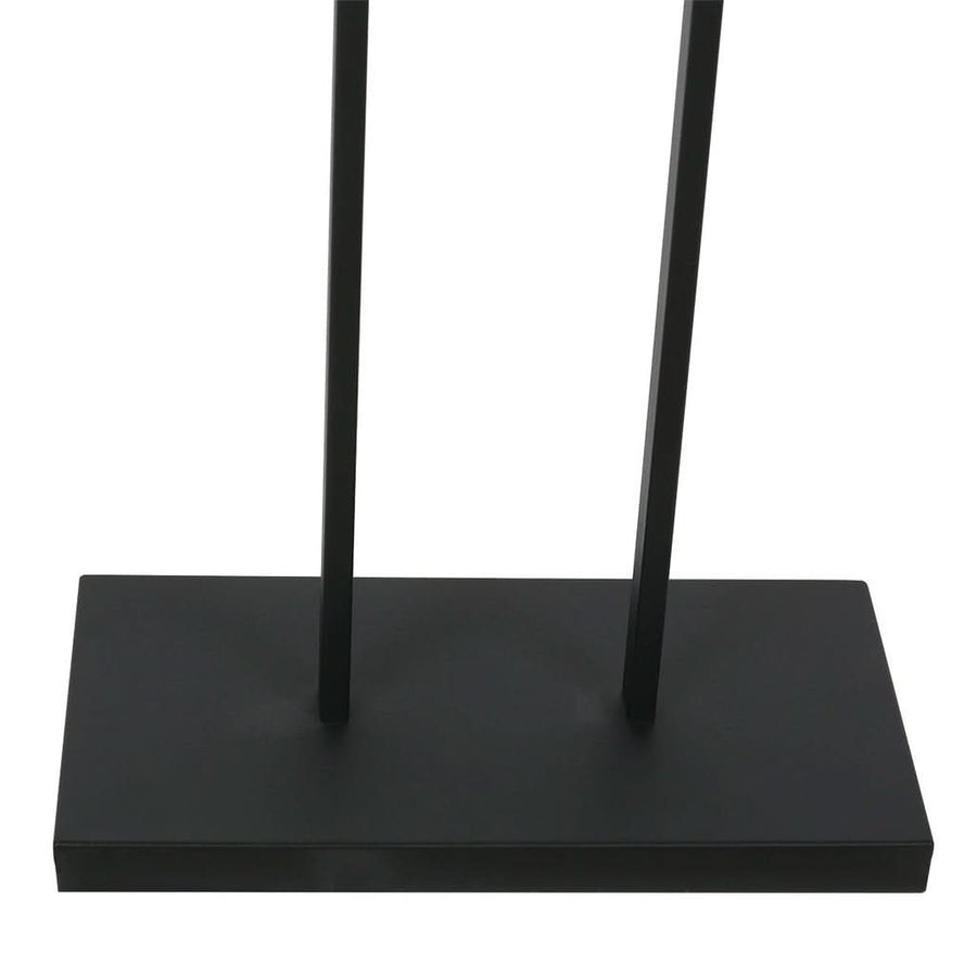 Détail de la base rectangulaire noire et des deux tiges verticales en métal.