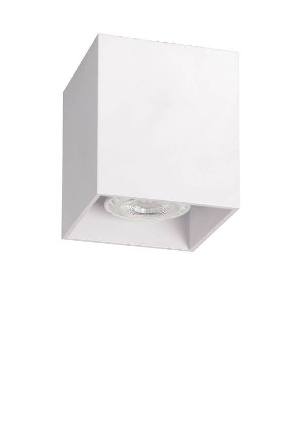 Produit blanc éteint vu de biais, lentille striée visible sous le boîtier cubique