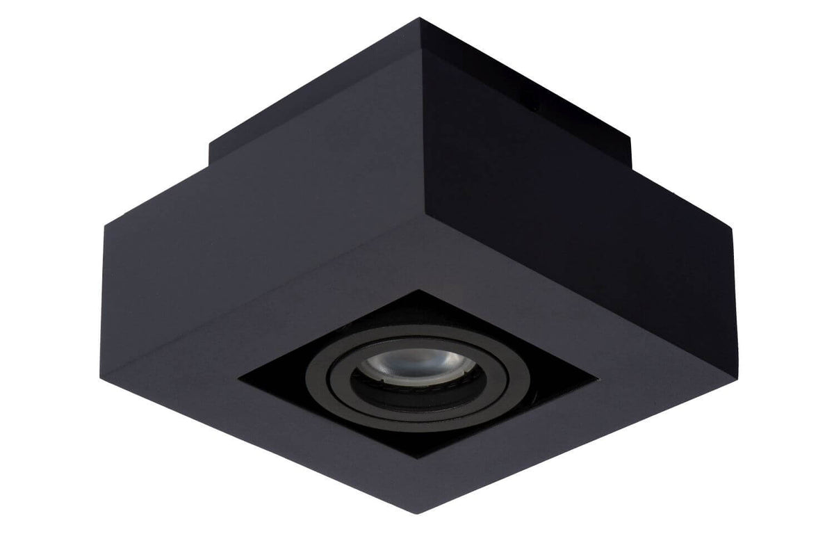 Produit éteint vu de dessous, boîtier cubique noir et lentille de verre