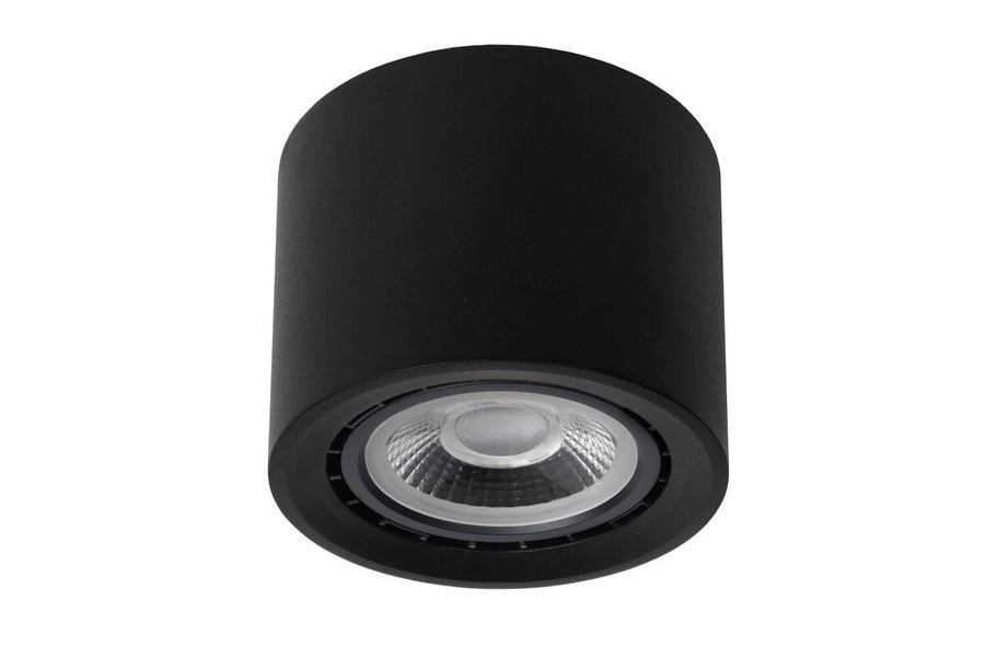 Plafonnier cylindrique noir éteint, réflecteur transparent et bord cannelé visibles.