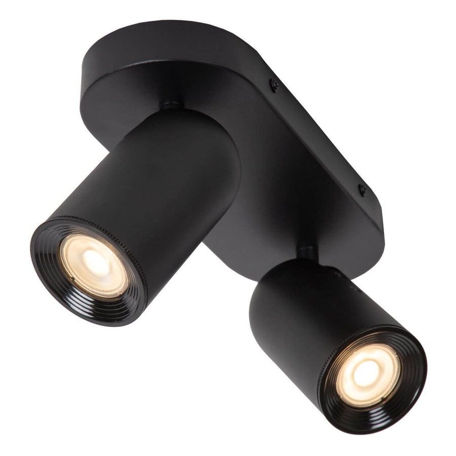 Gros plan d'une tête cylindrique noire mate, bague striée et vis de fixation apparentes