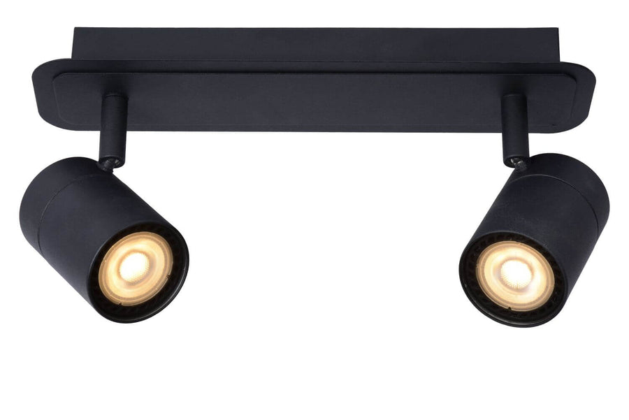 Vue de face du plafonnier noir deux spots cylindriques orientables allumés sur fond blanc.