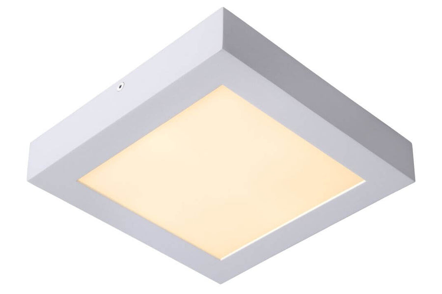 Vue en biais du luminaire blanc carré, cadre épais et diffuseur à lumière chaude
