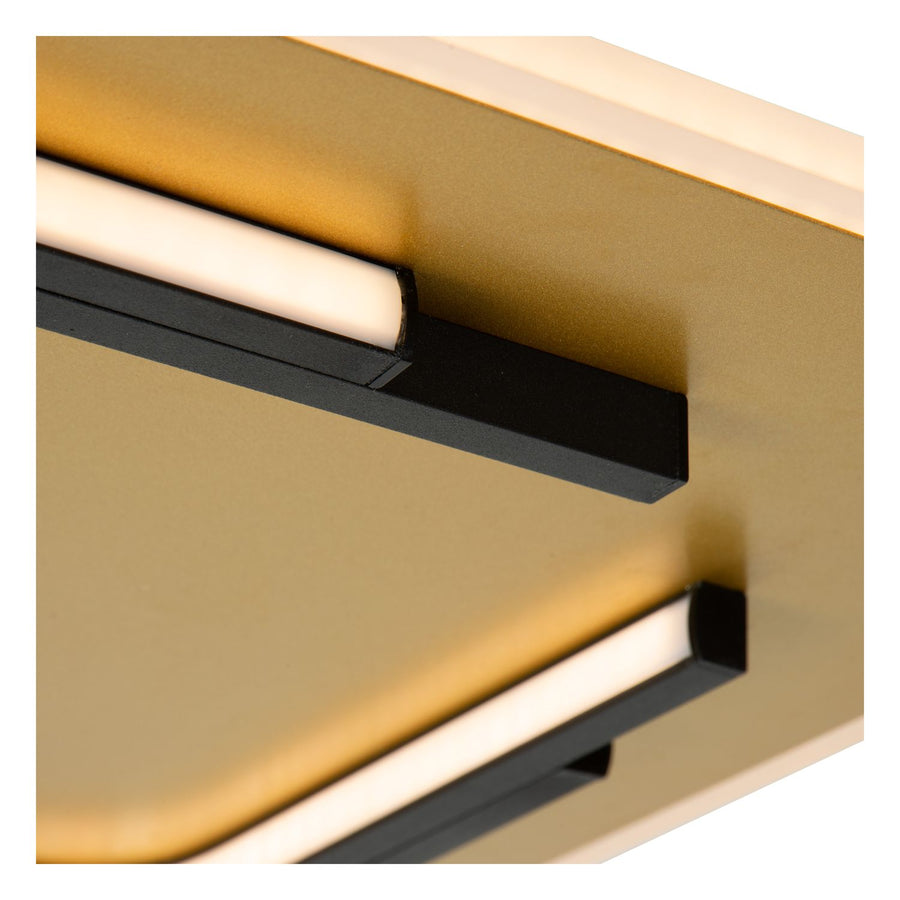 Détail rapproché de la finition dorée mate et du profilé aluminium noir