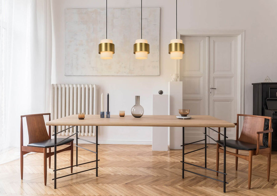 Vue large de la salle à manger avec les trois luminaires suspendus au-dessus de la table