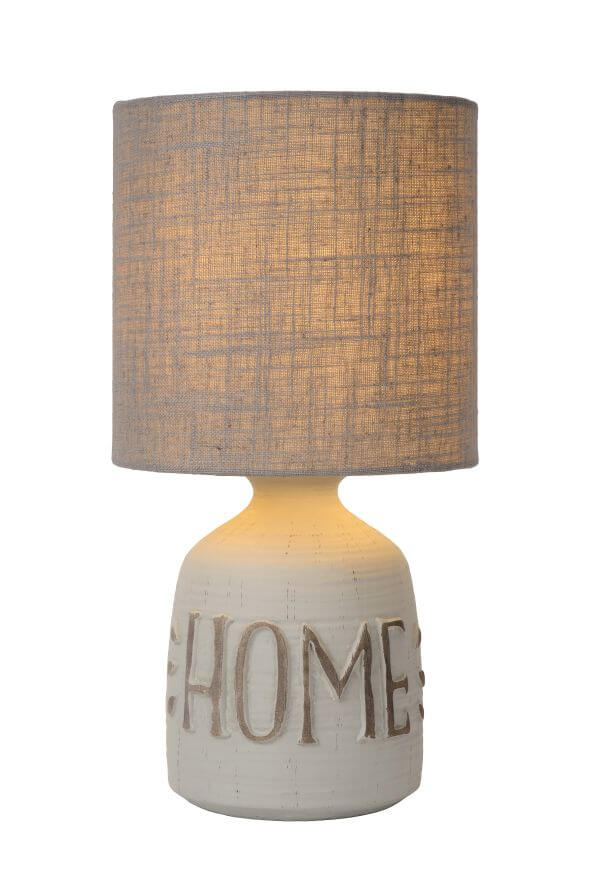 Lampe à poser grise de face, abat-jour en coton et base avec inscription HOME.