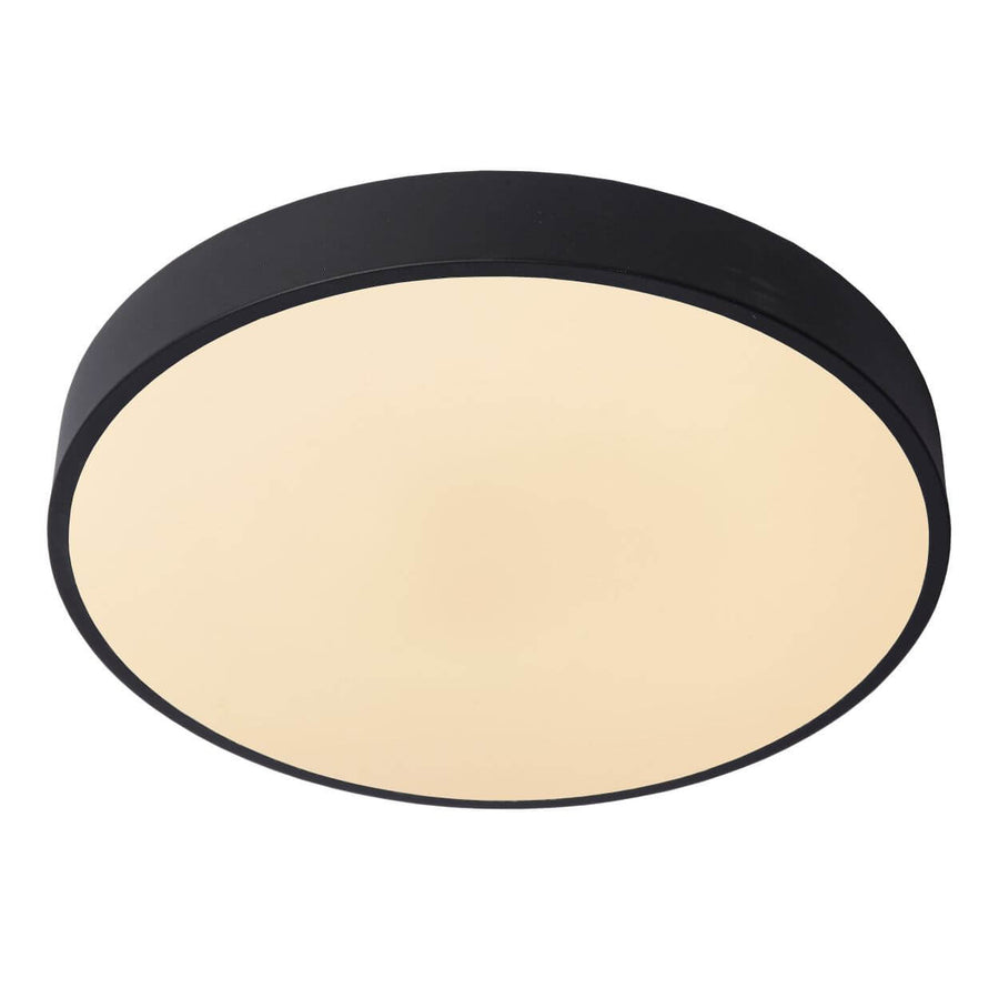 Vue de face du luminaire, disque opale lumineux cerclé d'un anneau noir mat