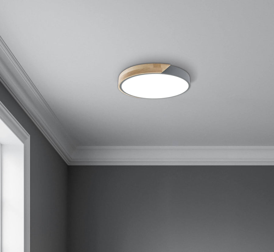 Plafonnier allumé fixé au plafond gris, vue rapprochée.