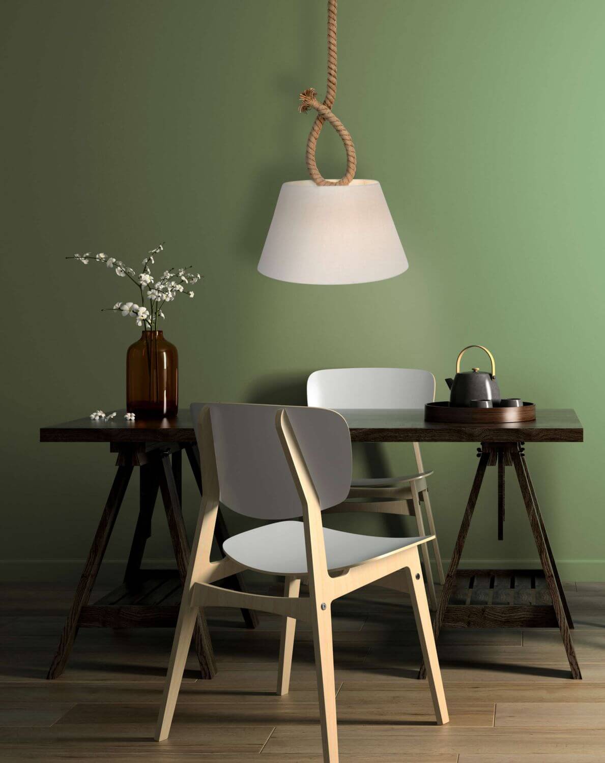 Suspension en corde éclairée au-dessus d'une table à manger devant un mur vert.