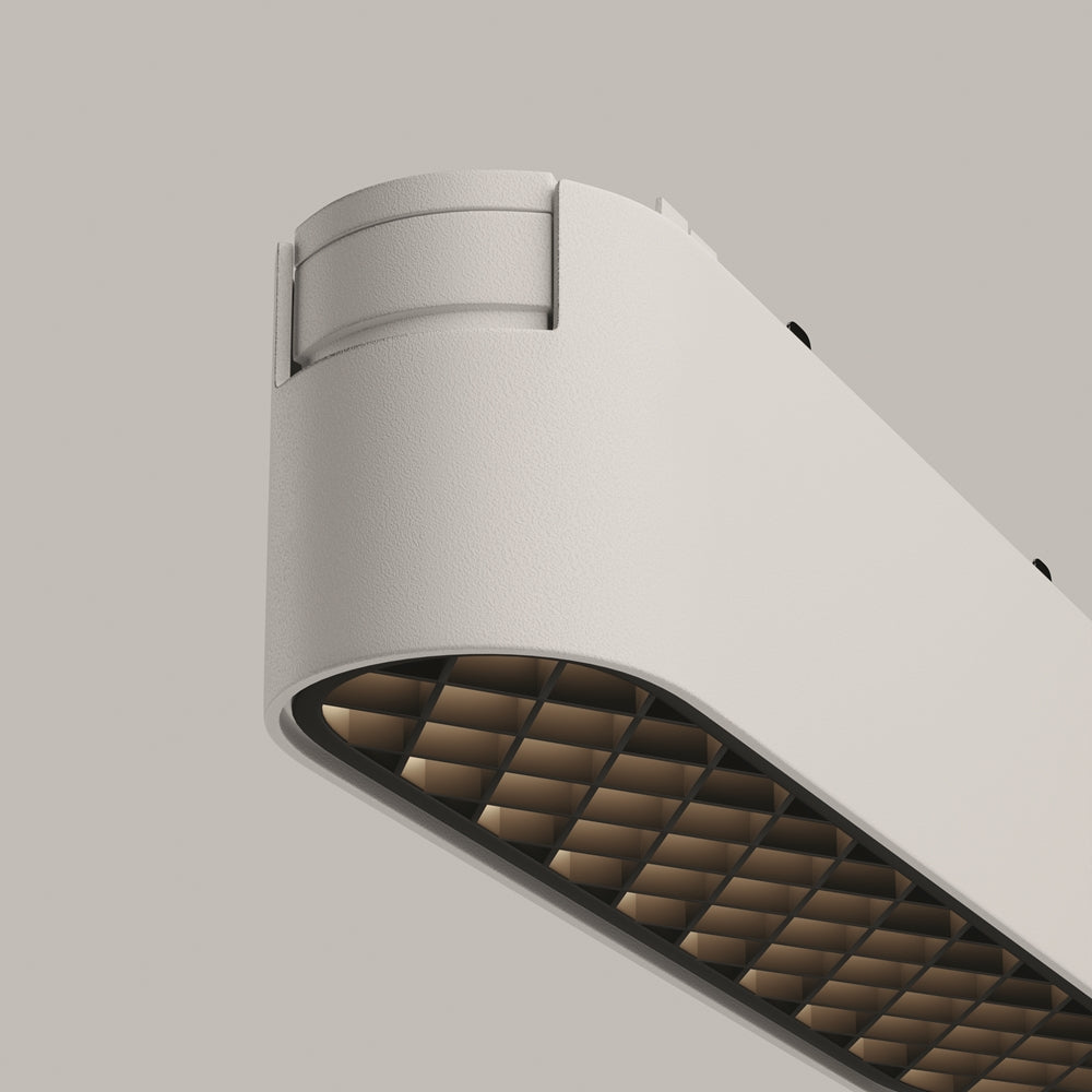 Détail rapproché de la finition blanc mat et de la grille alvéolaire interne.