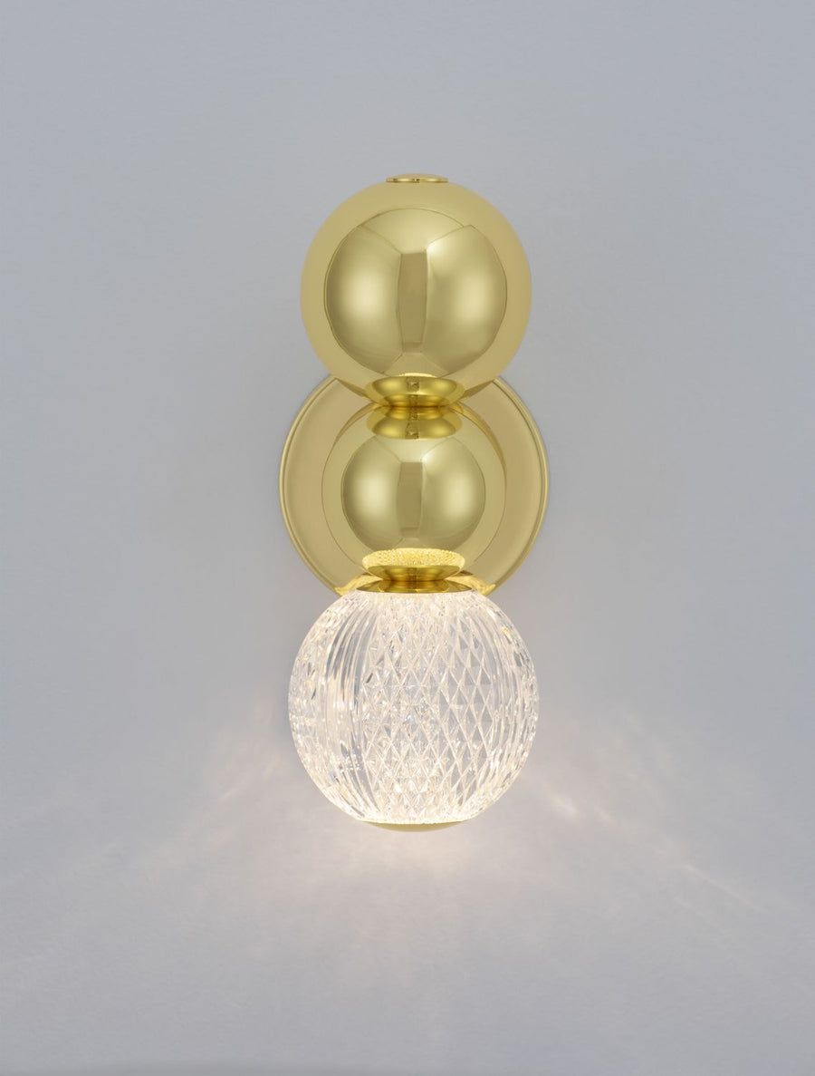 Applique allumée, la lumière chaude traverse le globe de verre texturé