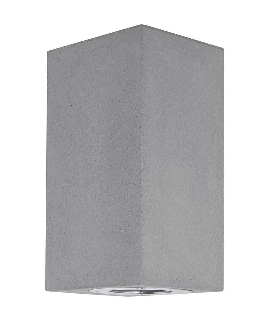 Vue de face du luminaire béton gris, diffuseur rond visible sous le boîtier