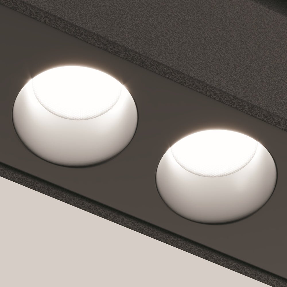 Détail rapproché de deux points lumineux ronds dans leur rail noir