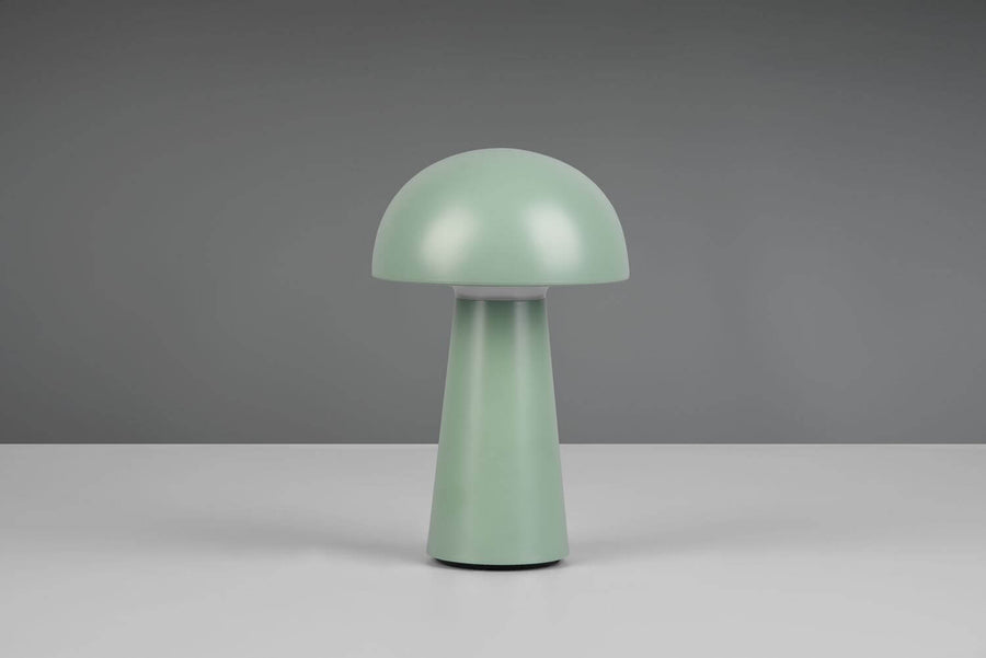 Lampe champignon verte éteinte, silhouette arrondie sur fond gris neutre.