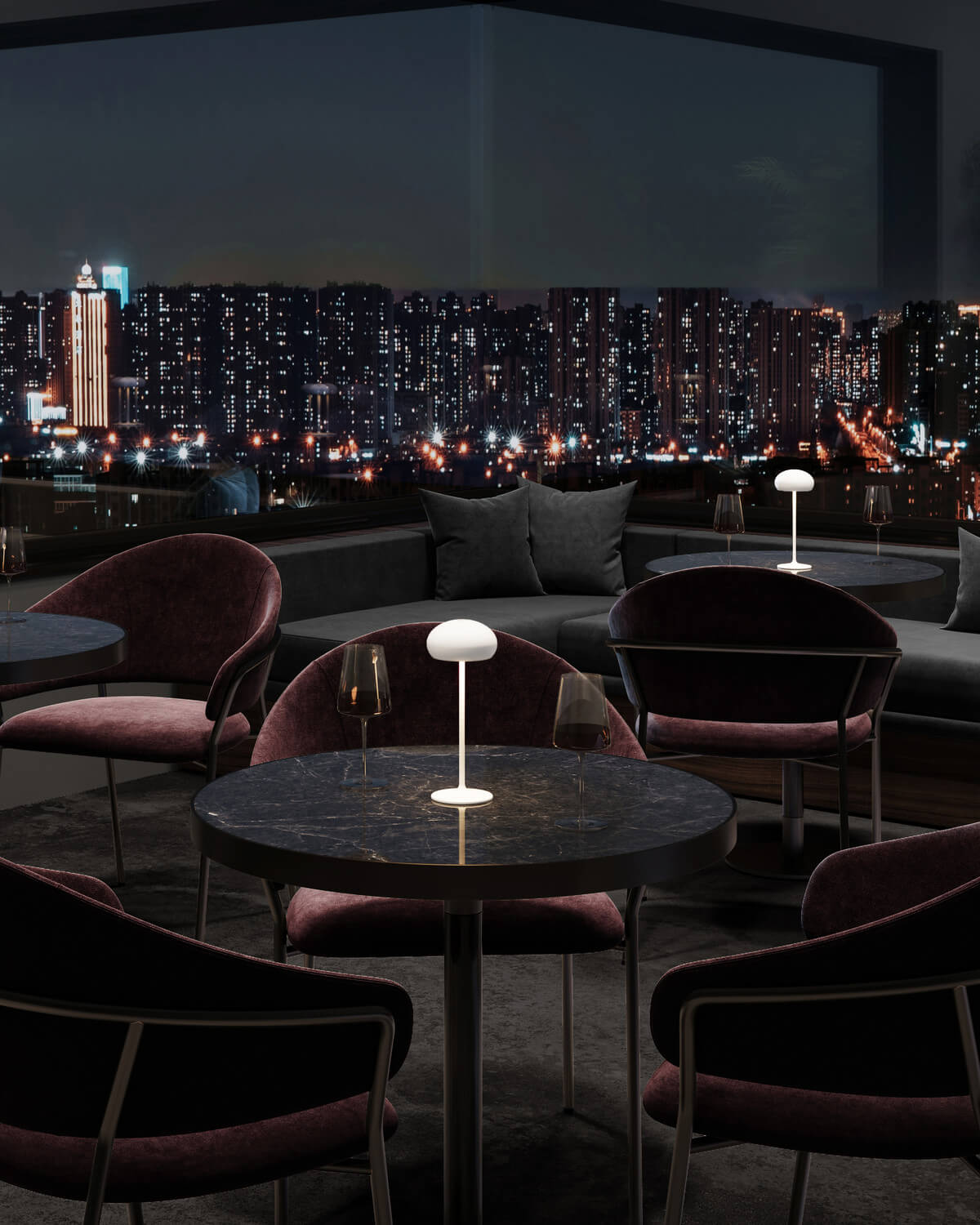 Vue d'ensemble du salon extérieur, plusieurs lampes éclairant les tables basses
